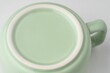 Closeup shot of the underside of a pastel green tea cup