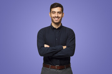 Wall Mural - Modern businessman in black shirt standing with crossed arms on purple background