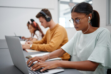 Leinwandbilder - Students, elearning and laptop in classroom education, learning and studying with technology indoors. Focused woman typing research essay or project on computer at university, college or school