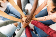 © Xavier Lorenzo - Multiethnic young friends people putting their hands together showing community, support, cooperation, unity and teamwork