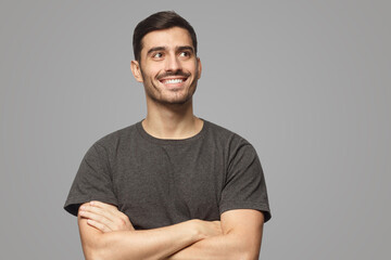 Canvas Print - Portrait of positive man pictured isolated on gray background