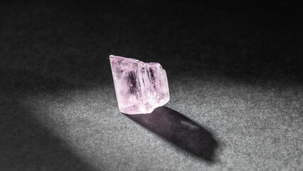 Kunzite crystal healing stone on black background