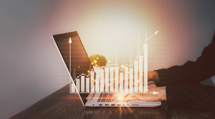 Startup success business concept. Businessman touching notebook (Laptop) with hologram of statistics graph and chart growing graph network connection. Planning and strategy concept.