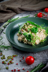 Wall Mural - Ptitim with mushrooms and cream sauce and green spinach leaves in a plate