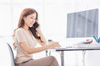© David - Freelance Smiling young asian business woman using computer laptop working at home Office, Happy business asian woman talking on mobile phone while analyzing weekly schedule in her notebook.