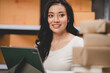 © chokniti - Asian woman e-business entrepreneur checking order and packing parcel box of product shipping delivery business, freelance marketing owner having online cyberspace to work with logistic package job