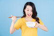 © Timeimage - Image of young Asian woman eating instant noodles