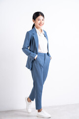 Full length photo of young Asian business woman on background