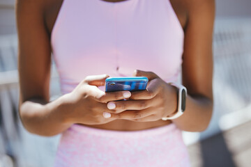 Hands, phone and black woman texting during workout outdoor, social media and internet browsing. Fitness, yoga and black girl reading online posts, checking message and taking a break from meditation