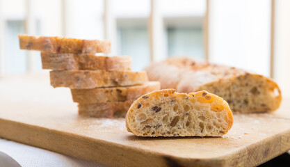 Wall Mural - fresh loaf of bread on wooden board