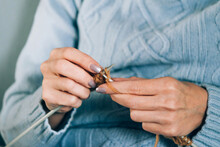Women's Needlework Hobby Knitting. Woman Knits On Knitting Needles