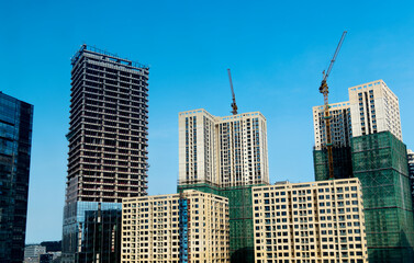 Canvas Print - New buildings with crane under construction