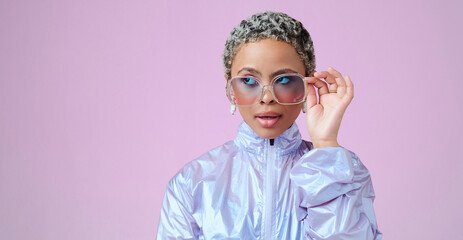 Wall Mural - Fashion, beauty and mockup with a black woman in glasses on a pink background in studio for advertising and marketing. Style, edgy and trendy with an attractive female posing with cool sunglasses