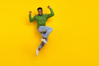 Full length body size view of attractive cheery guy jumping rejoicing attainment isolated over bright yellow color background