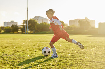 Wall Mural - Soccer, football and sports girl training on field preparing for match, game or competition on outdoors grass pitch. Health, fitness and kid kick ball learning sport for wellness, running or exercise