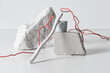 © TrueFrame Collective - Horizontal studio shot of still life composition made of various white objects and red wire, white background