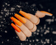 Beautiful stylish art manicure. Halloween manicure design ideas. Stylish orange nails with pumpkin. Close up photo.