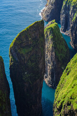 Dunnesdrangar is a name for the two 70 meter high sea stacks on Vágar island's south coast in Faroe islands.