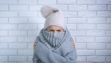 Lady With Problem Central Heating. A Young Frustrated Woman In Woolen Scarf Freezing In A Flat With Cool Temperature. A Concept Of Heating Crisis In The World.