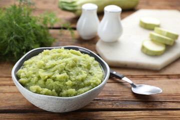 Bowl with tasty puree and ingredients on wooden table, closeup