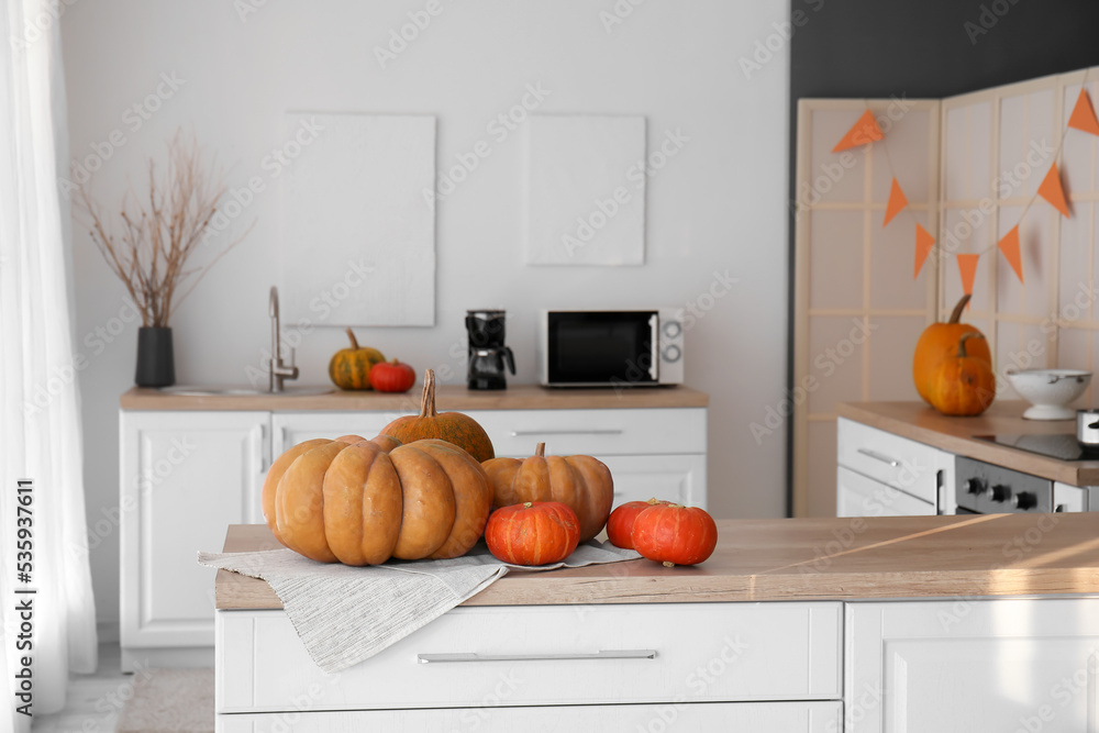 Halloween pumpkins on counter in modern kitchen