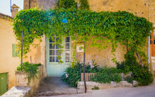 Blue Door, Old Stone House And Green Arbor In The Medieval Village Of Saint Montan In The South Of France (Ardeche)