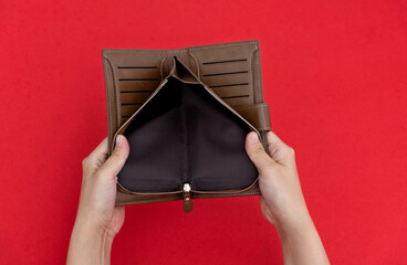 woman hand open an empty wallet on red background
