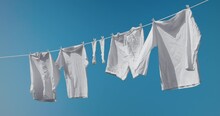 Bright White Clothes Hanging Out On Washing Line