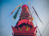 Salak yom at Wat Phra That Hariphunchai in Lamphun. The tradition of making merit, the tall dyed lott trees are decorated with different colored paper and clothing items to pay homage to the souls.