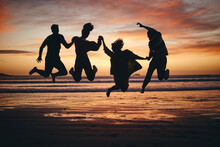 Freedom, Jump And Silhouette Of Friends At The Beach And Travel On Brazil Vacation For Success, Happy Or Motivation. Teamwork, Collaboration And Shadow Of People At Sunset For Summer, Youth And Fun