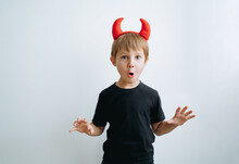Halloween Concept. Cute Little Boy With Red Devil Horns Isolated On White Background