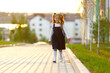 © Ruslan Ivantsov - a little girl goes to school through the park along the path.