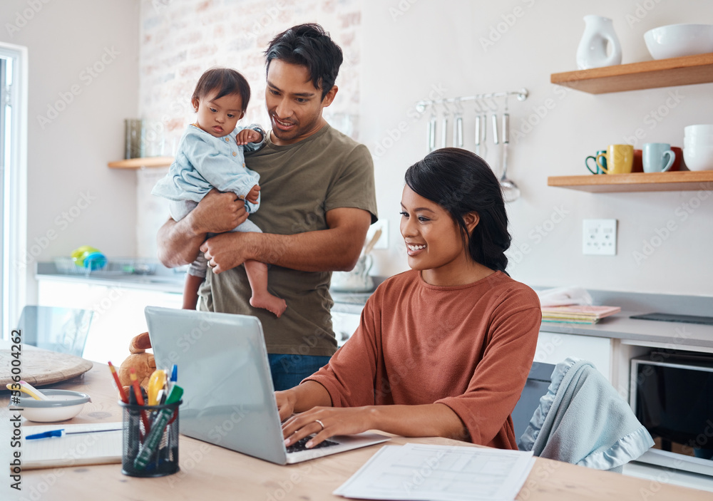 Internet, family and parents doing research on down syndrome with baby on a laptop in their house. Mother and father with smile for child and working on taxes or finance budget on the computer