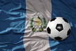 vintage football ball on the waveing national flag of guatemala background. 3D illustration