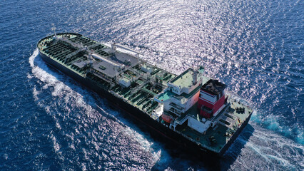 Aerial drone photo of crude oil super tanker cruising in low speed in deep blue sea of Saronic gulf near port of Piraeus, Attica, Greece