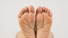 Asian Male Soles Barefoot Are Isolated On White Background.