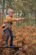 © Tatiana - Happy boy cheering while climbing a net. Child crawling on rope mesh at playground. High quality photo