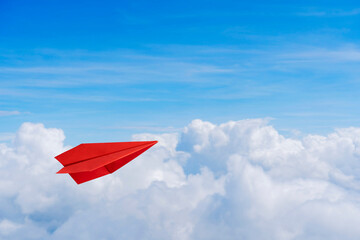 Wall Mural - Paper red planes in blue sky. Sky background. The atmosphere is on the plane, sky is full of clouds floating around