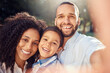 © David L/peopleimages.com - Portrait, selfie and happy family in a park, relax and smiling while taking a picture and bonding in nature. Love, smile and face of excited kid enjoying quality time with loving, caring mom and dad