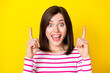 Closeup photo of young attractive woman directing fingers up click link advert isolated on yellow color background