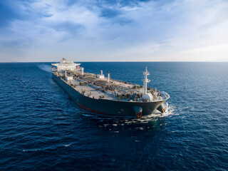 Wall Mural - Aerial front view of a heavy loaded crude oil cargo tanker in motion over blue ocean