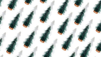 Banner of small green decorative Christmas trees with shadows on a white background. Flat lay Christmas pattern