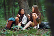 © standret - Two girls is in the forest having a leisure activity, discovering new places