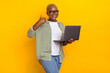 © deagreez - Photo of attractive cheerful girl demonstrate thumb up feedback hold netbook isolated on yellow color background