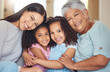 © David L/peopleimages.com - Portrait, smile and happy family on mothers day with grandmother, mom and girl siblings hugging at home. Mama, children and elderly woman love relaxing, bonding and enjoying quality time together