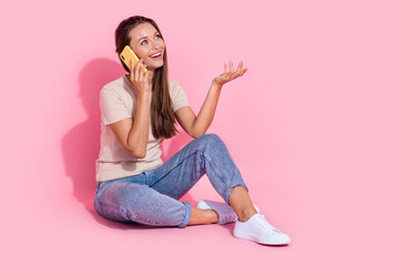 Poster - Full length photo of funny dreamy lady wear beige t-shirt communicating modern gadget looking empty space isolated pink color background