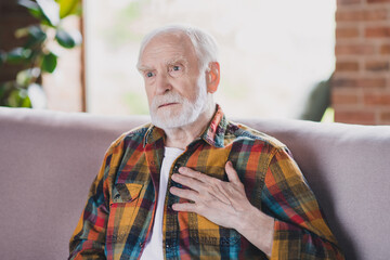 Poster - Photo of retired old man granddad grey hair nervous have heart pain health discomfort wear casual checkered look sit sofa indoors home room