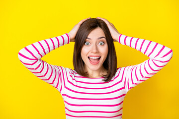 Wall Mural - closeup photo of young beautiful woman hands hold head crazy amazed watched film isolated on yellow 