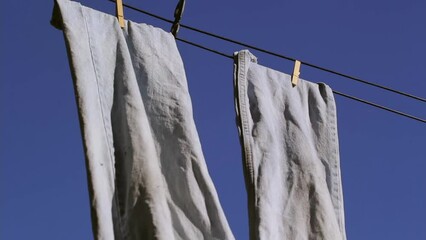 Wall Mural - Tight shot of blue jeans on clothes or wash line