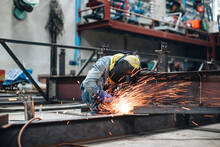 Worker Using Electric Wheel Spark Grinding On Metal Steel Is Part Of Beam Structure